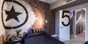 Industrial-style-bedroom-with-brick-wall-and-trendy-graffiti-art